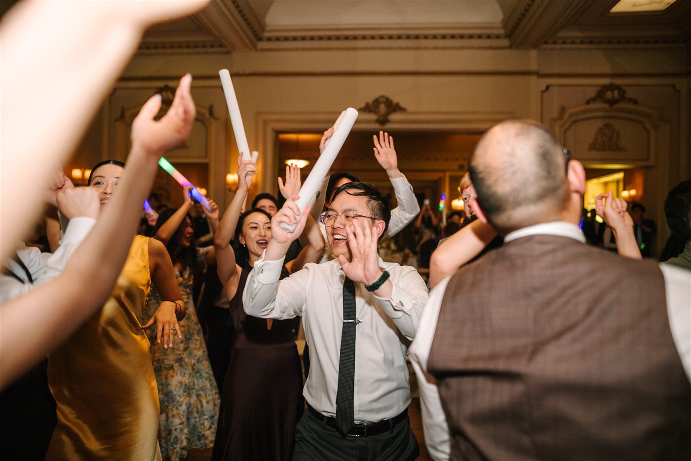 Guests dancing with light-up glow sticks