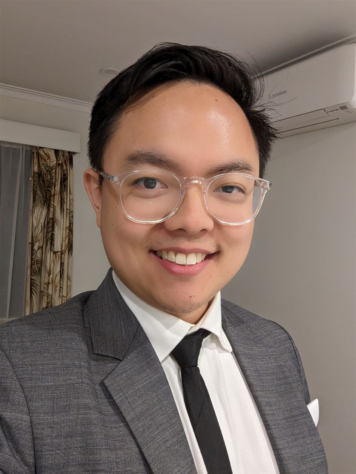 Vince smiling in a suit and tie